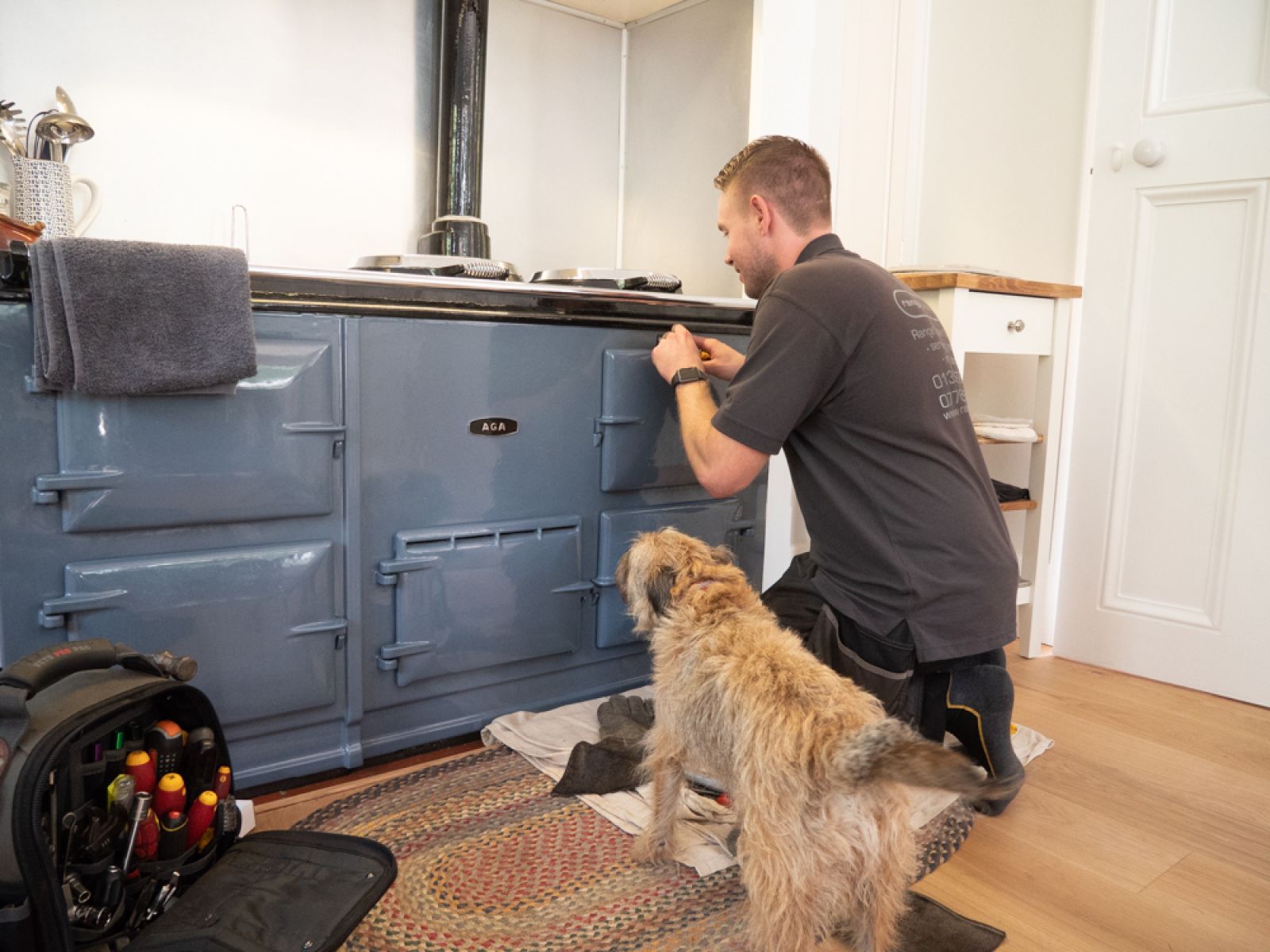 Range Experts servicing an Aga with the customer's dog